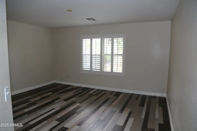a view of a room with wooden floor