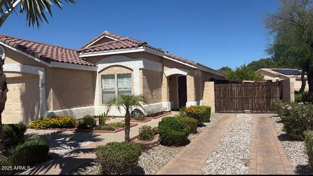 a front view of a house with garden