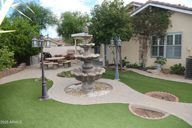 a view of a house with backyard porch and sitting area