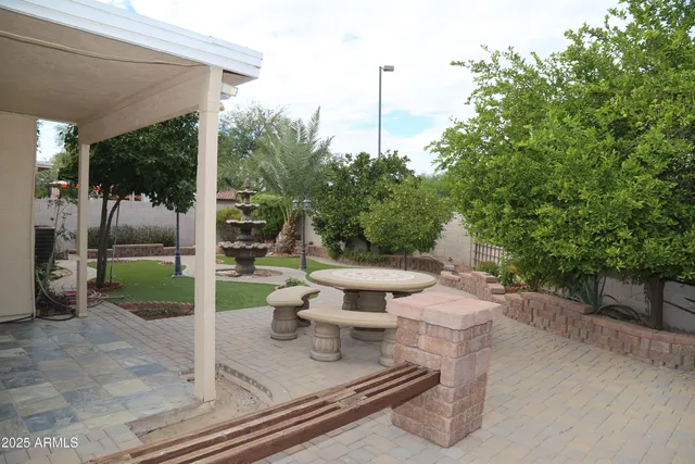 a view of a patio with a dining table and chairs