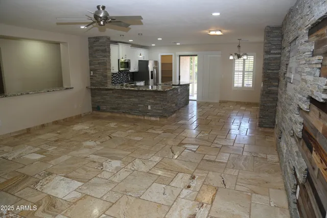 a view of a kitchen with a sink and a fireplace