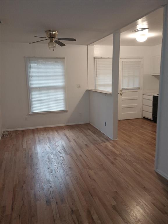 139 East Hill Street Decatur, GA 30030 - Photo 8 of 15 an empty room with wooden floor cabinet and windows