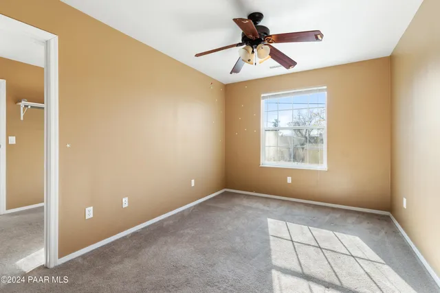 a view of room with a ceiling fan