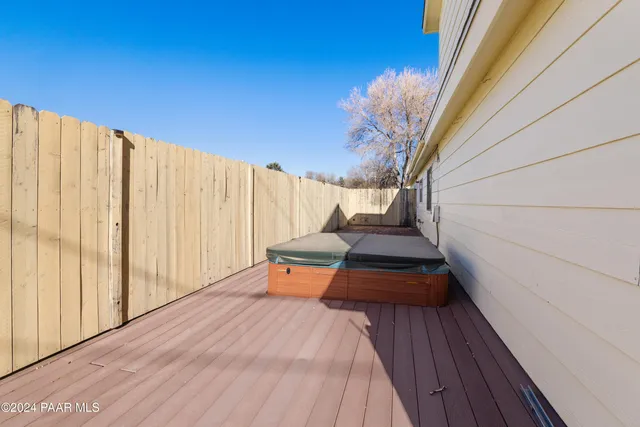 a balcony with wooden floor and outdoor space