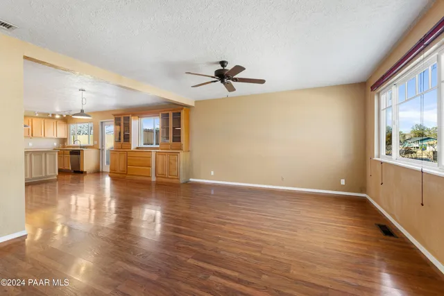 a view of a kitchen with a stove wooden floor and a kitchen