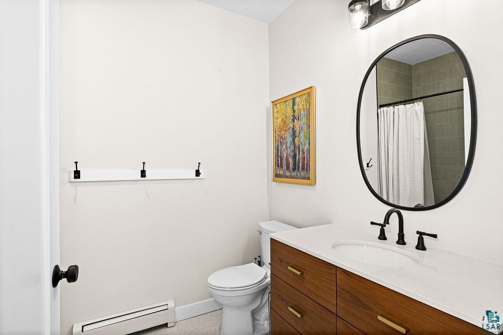 2236 Hoover Street Duluth, MN 55811 - Photo 24 of 52 Full bath featuring a baseboard radiator, vanity, and a shower with shower curtain