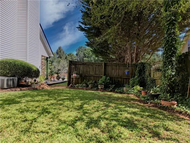 a view of a chairs and table in backyard of the house