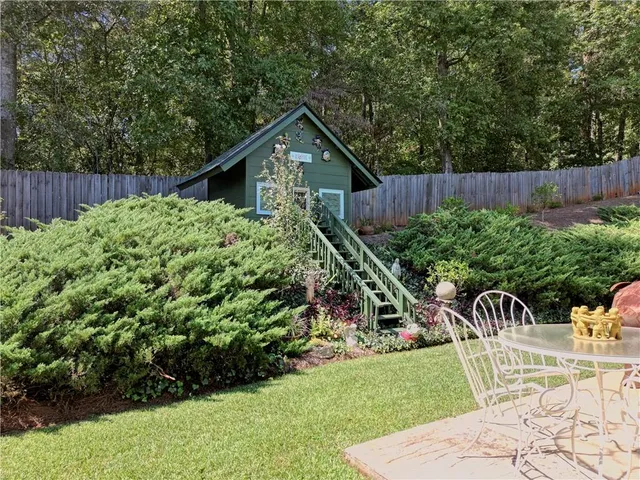 a backyard of a house with outdoor seating