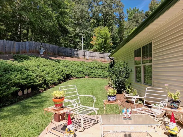 an aerial view of house with yard and trees
