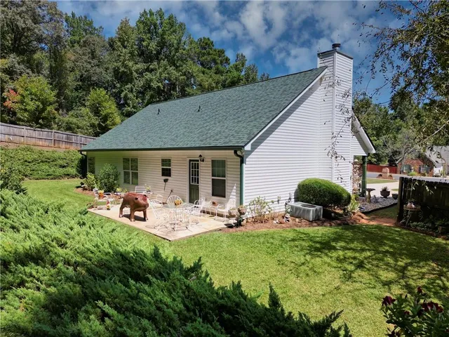 a backyard of a house with outdoor seating