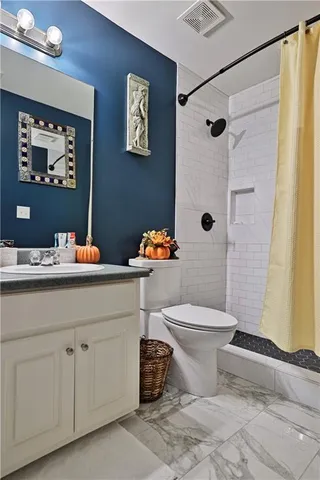 a bedroom with bed and a chandelier