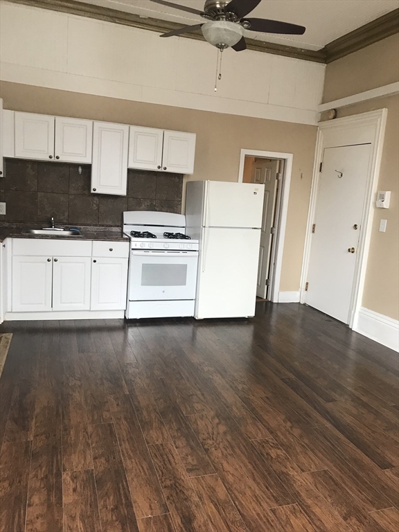 14 Monument Square, Unit 26 Boston, MA 02129 - Photo 1 of 7 a kitchen with granite countertop a stove a sink and a refrigerator