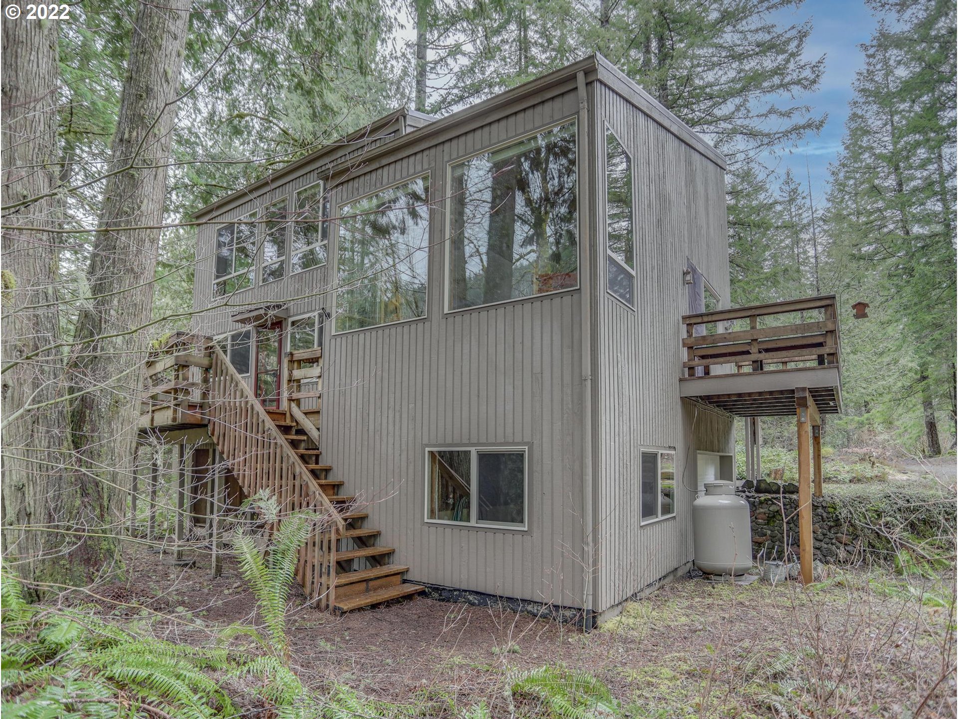 73000 East Village Loop Road Rhododendron, OR 97049 - Photo 2 of 32 a front view of a house with a yard