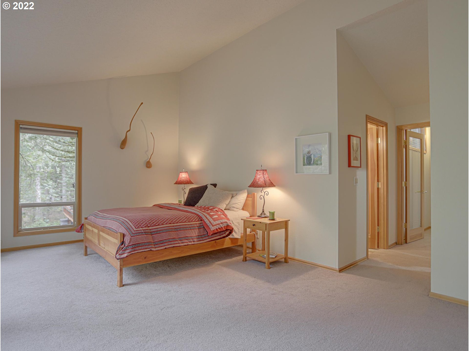 73000 East Village Loop Road Rhododendron, OR 97049 - Photo 24 of 32 a spacious bedroom with a bed and a window