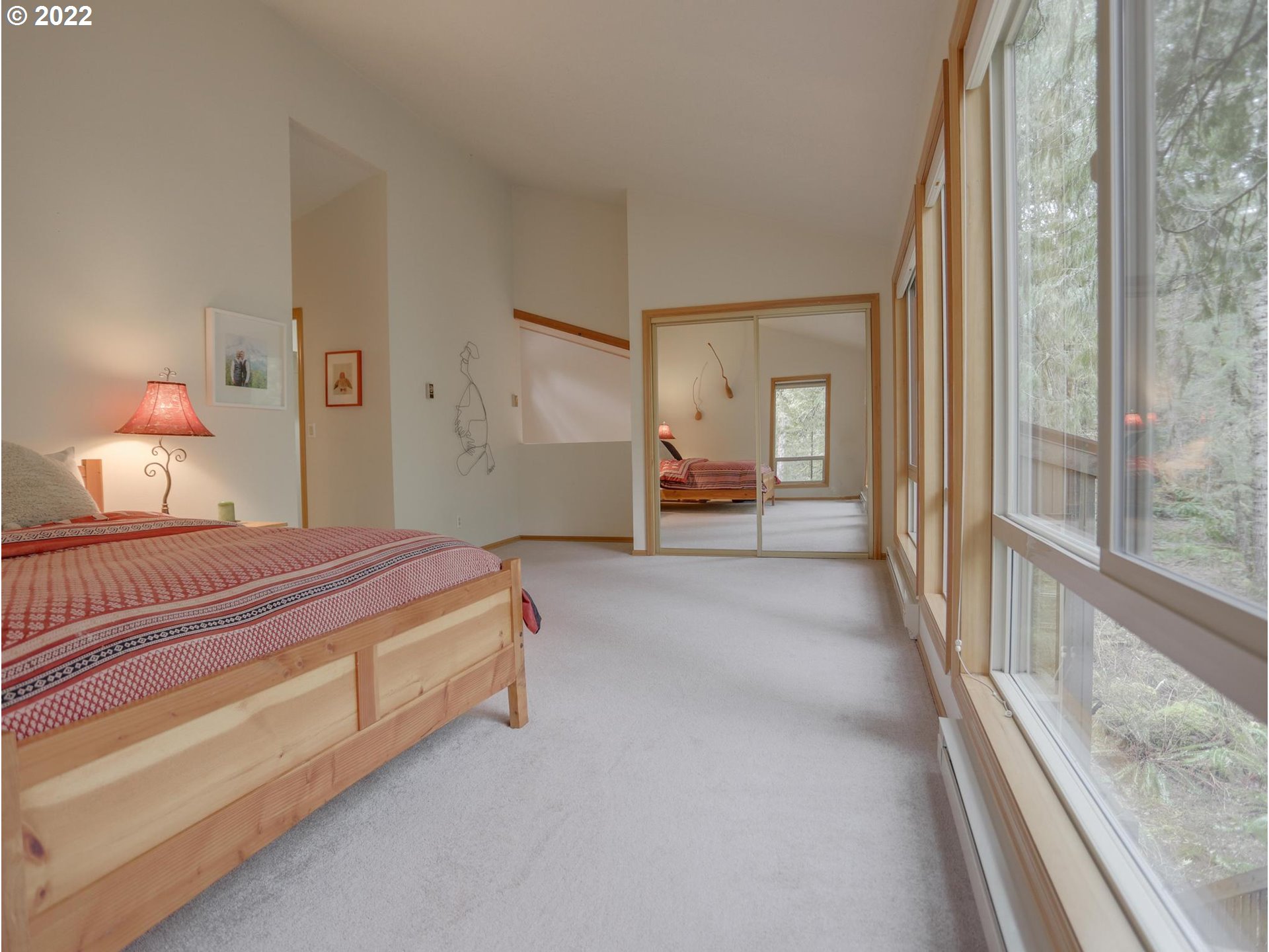73000 East Village Loop Road Rhododendron, OR 97049 - Photo 29 of 32 a spacious bedroom with a bed and a large window