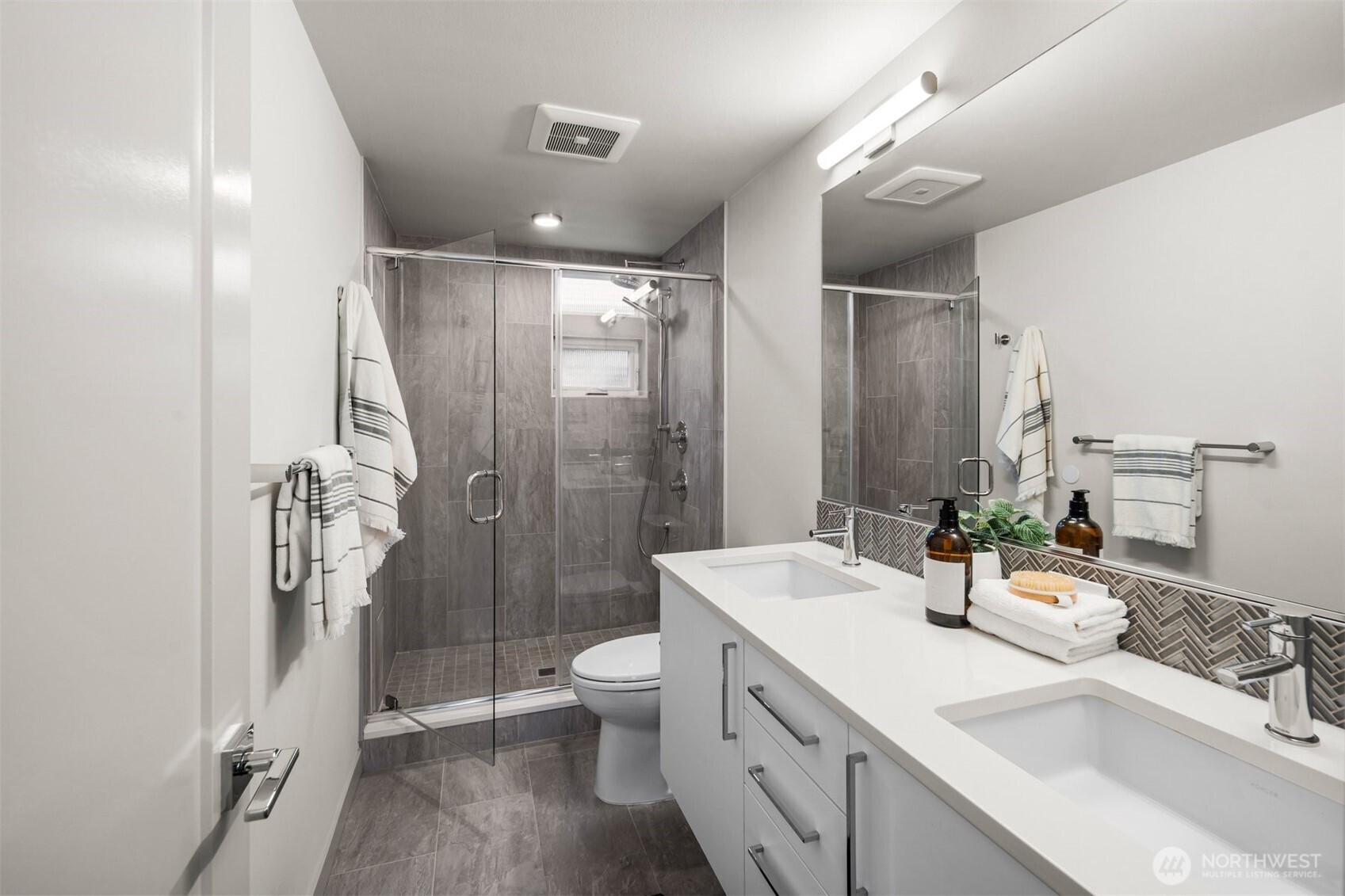728 North 43rd Street Seattle, WA 98103 - Photo 19 of 29 a bathroom with a double vanity sink toilet and shower