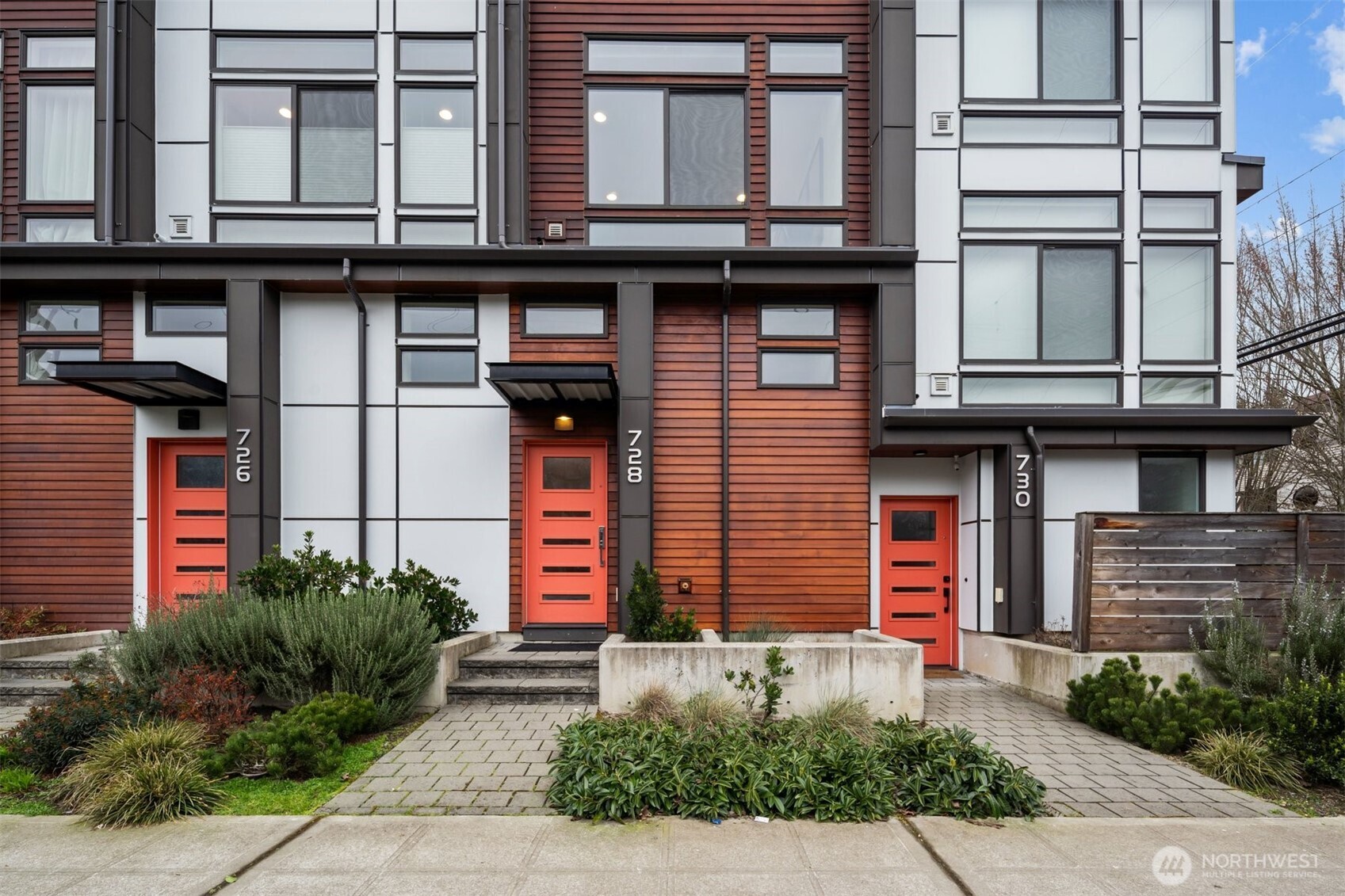728 North 43rd Street Seattle, WA 98103 - Photo 26 of 29 a building with potted plants in front of it