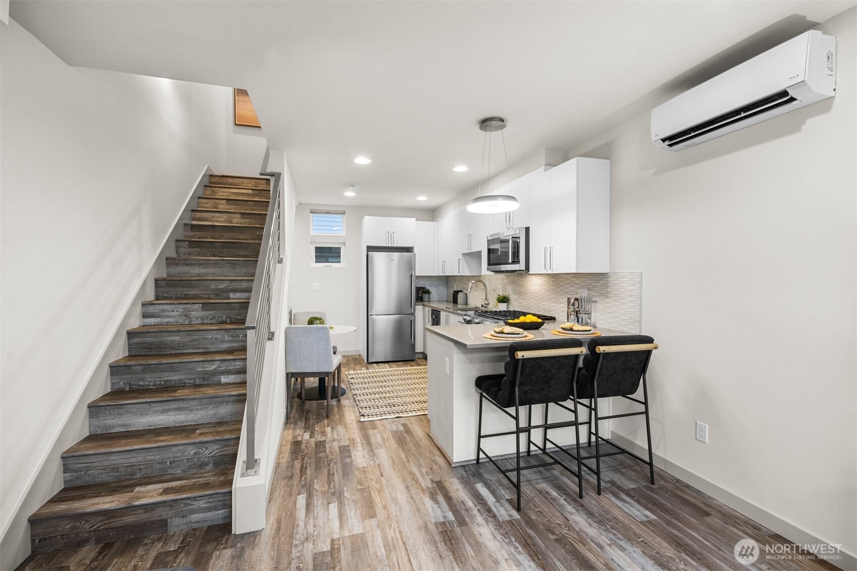 728 North 43rd Street Seattle, WA 98103 - Photo 9 of 29 a kitchen with stainless steel appliances granite countertop a refrigerator and a stove top oven