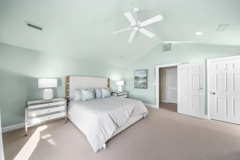 a room with a large window and chandelier