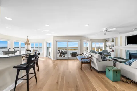 a living room with fireplace furniture and a wooden floor