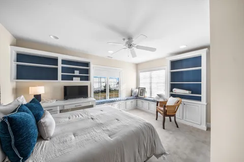 a bedroom with a large bed and a chandelier