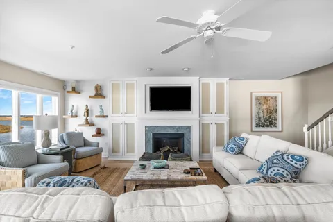 a living room with furniture a fireplace and a flat screen tv