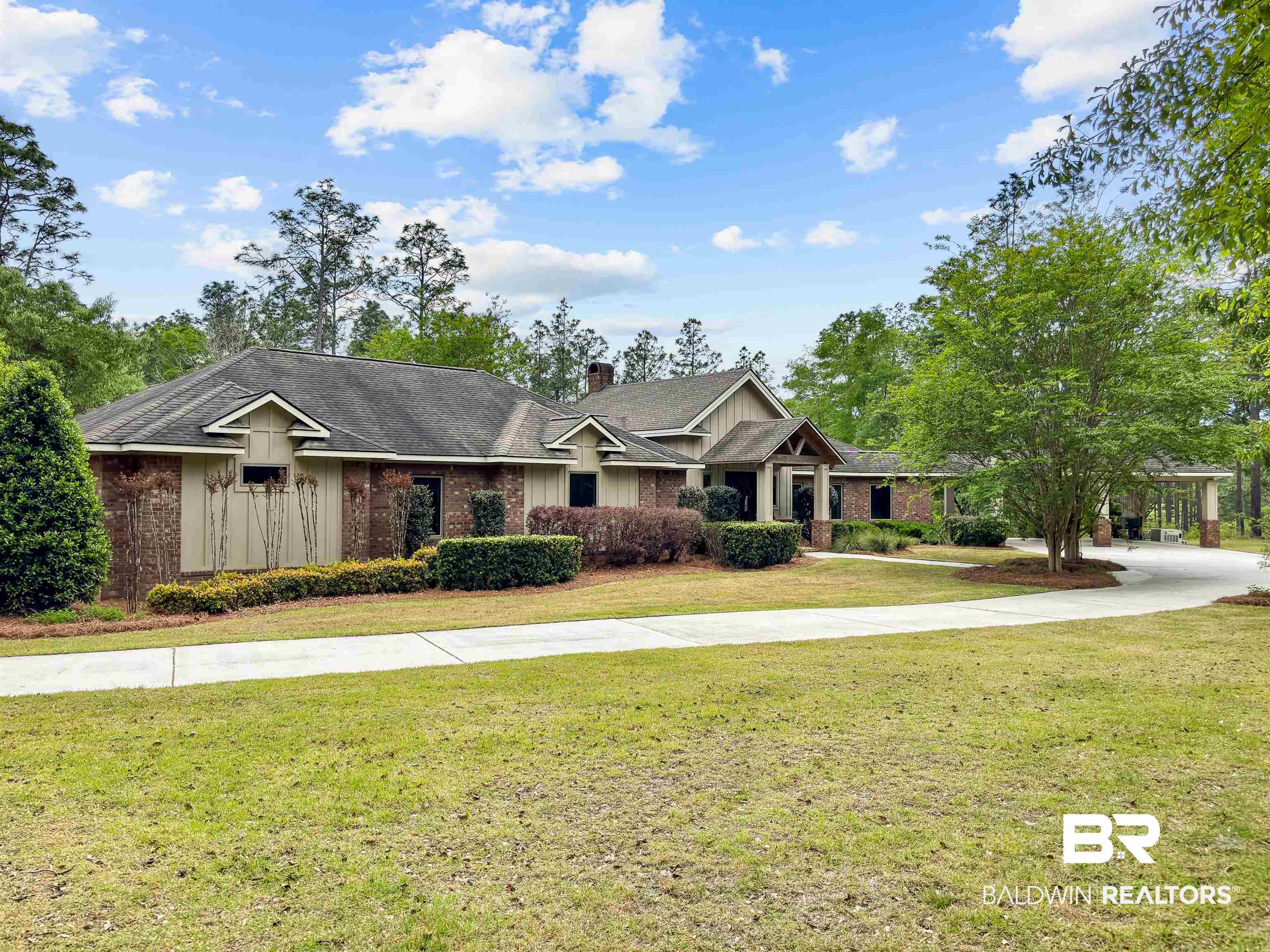 47252 Emmons Road Bay Minette, AL 36507 - Photo 2 of 50 Craftsman house featuring a front yard, brick siding, a chimney, and board and batten siding