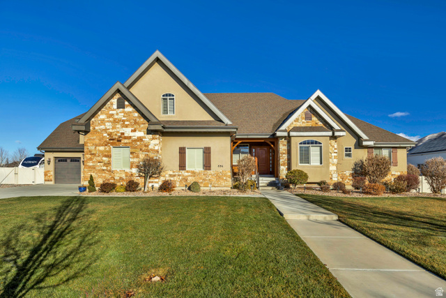 896 West 675 South Mapleton, UT 84664 - Photo 74 of 77 Craftsman house featuring a front yard, stucco siding, stone siding, and covered porch