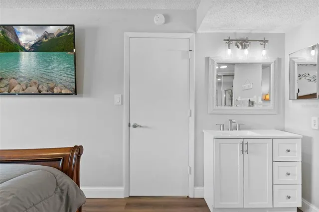 a view of hallway with mirror and furniture