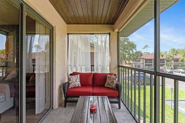 a balcony with furniture and a potted plant