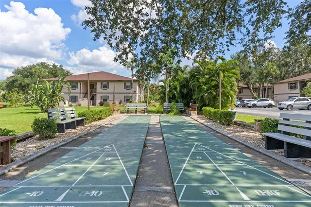 a row of palm trees in front of a house