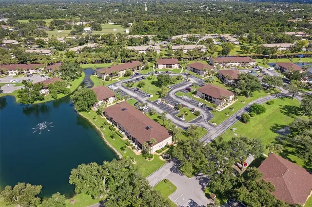 an aerial view of residential house with outdoor space and lake view