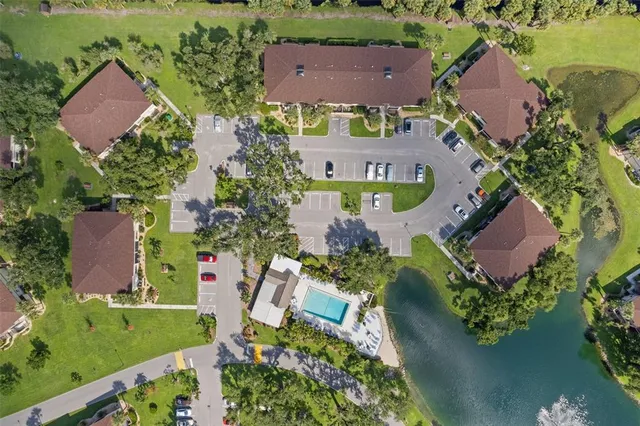 an aerial view of lake and residential houses with outdoor space