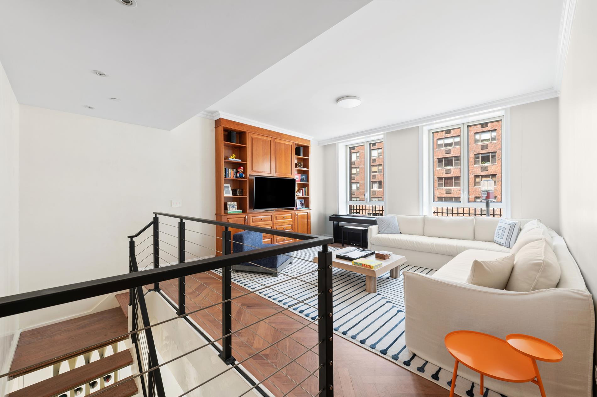 330 East 72nd Street, Unit 9/10 Manhattan, NY 10021 - Photo 9 of 17 a living room with furniture and a flat screen tv
