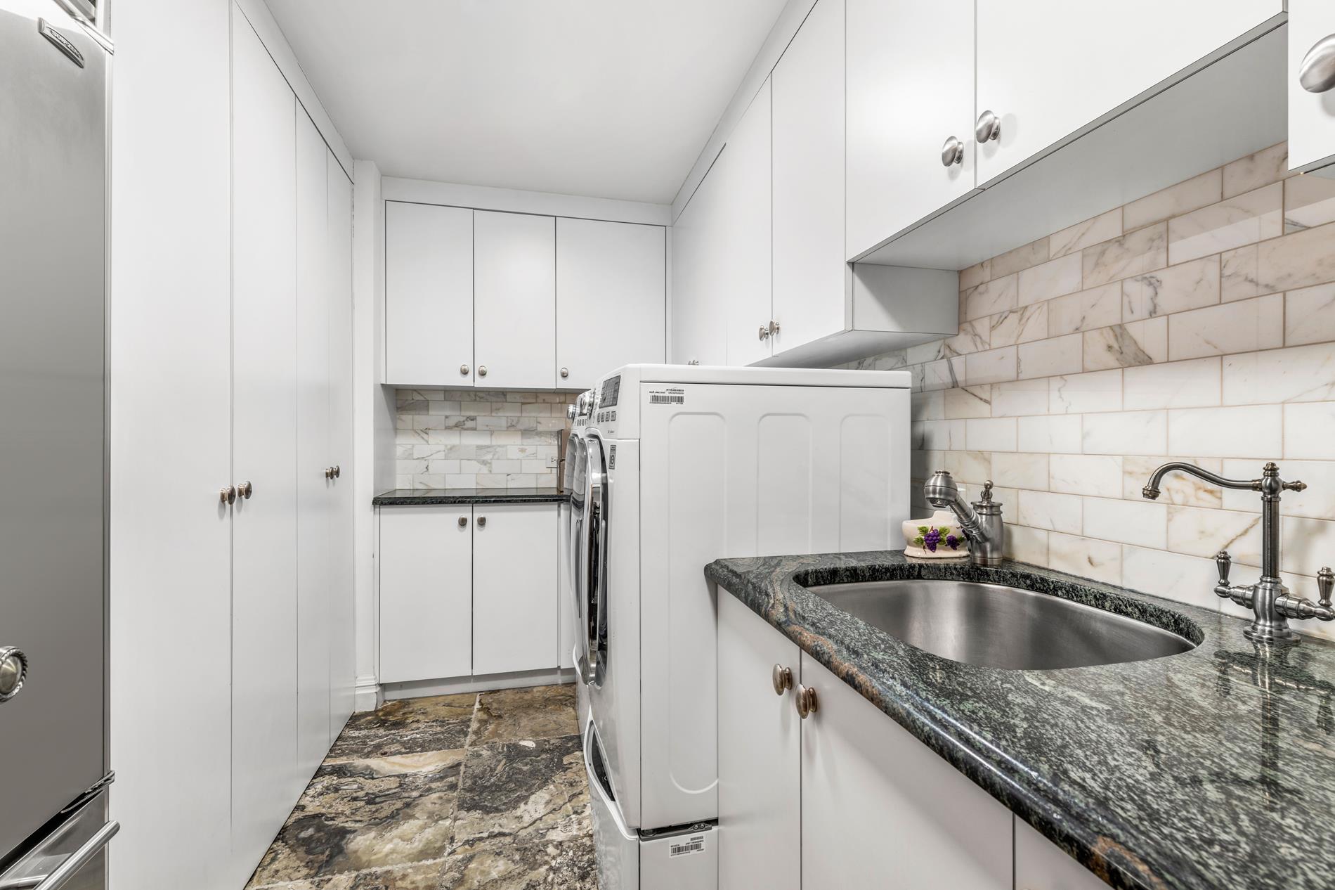 330 East 72nd Street, Unit 9/10 Manhattan, NY 10021 - Photo 13 of 17 a kitchen with a granite countertop sink and refrigerator