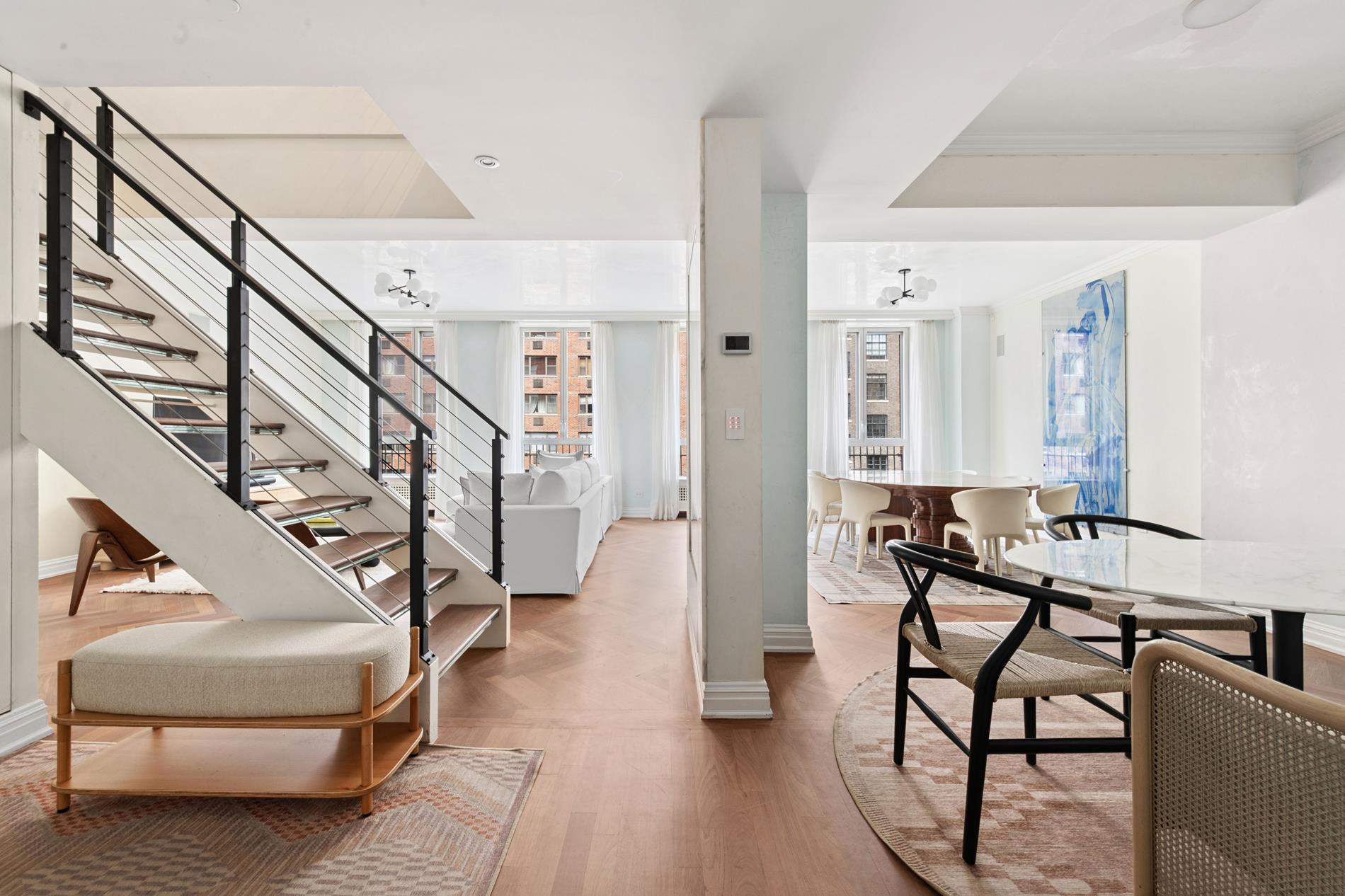 330 East 72nd Street, Unit 9/10 Manhattan, NY 10021 - Photo 2 of 17 a living room with furniture and a stairs