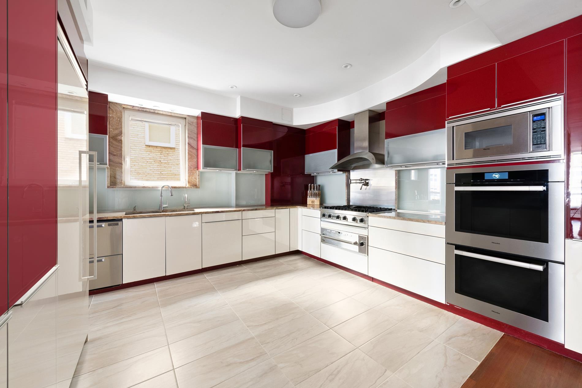 330 East 72nd Street, Unit 9/10 Manhattan, NY 10021 - Photo 4 of 17 a kitchen with stainless steel appliances kitchen island granite countertop a stove a sink and a microwave