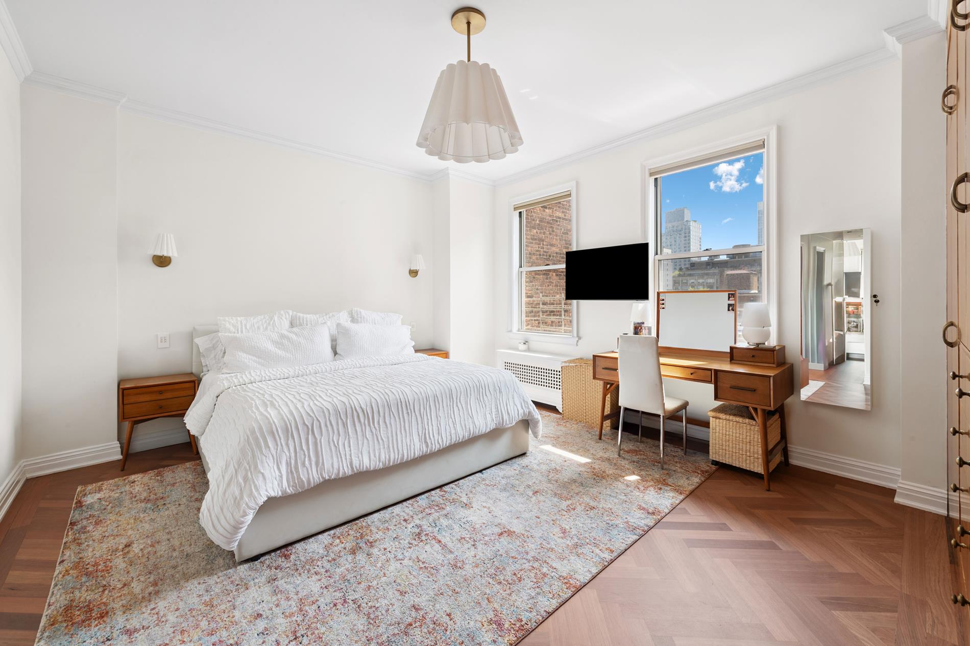 330 East 72nd Street, Unit 9/10 Manhattan, NY 10021 - Photo 5 of 17 a bedroom with a large bed and a chandelier