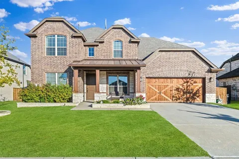 a front view of a house with a yard and porch