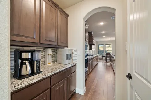 an open kitchen with granite countertop a view of living room
