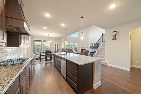 a large white kitchen with a large island