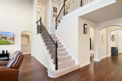 a view of entryway and hall with wooden floor