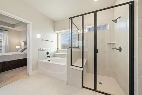 a bathroom with a tub shower and sink