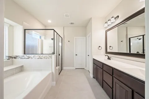 a spacious bathroom with a double vanity sink mirror double and bathtub