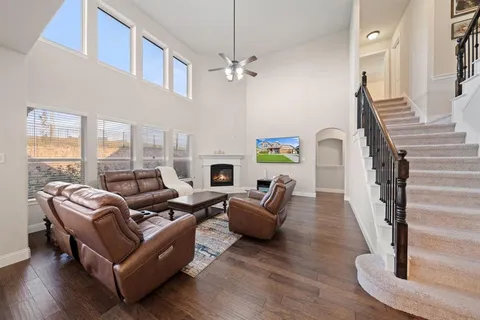 a living room with furniture and a chandelier