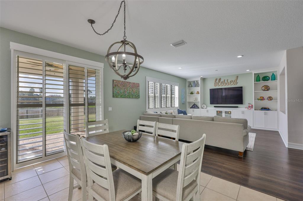 5409 Hammock View Lane Apollo Beach, FL 33572 - Photo 13 of 68 a view of a dining room with furniture window and wooden floor