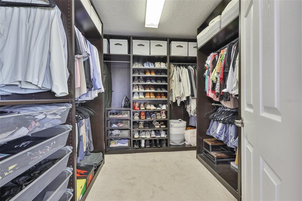 5409 Hammock View Lane Apollo Beach, FL 33572 - Photo 31 of 68 a view of walk in closet with clothes and shoes