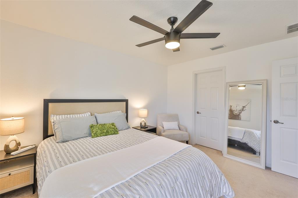 5409 Hammock View Lane Apollo Beach, FL 33572 - Photo 36 of 68 a bedroom with a bed and a large mirror