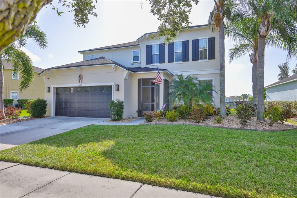 5409 Hammock View Lane Apollo Beach, FL 33572 - Photo 41 of 68 a front view of a house with a yard and garage