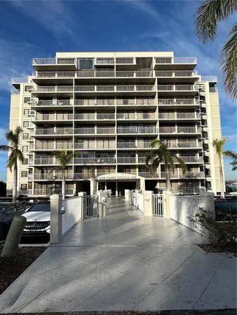 a view of pool with outdoor seating and buildings